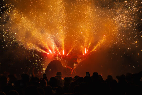 Dragon performing a pyrotechnic show from his head in Correfoc and Devils in granollers during the traditional major festival. People record with their mobile phones and dance under the fire and the s