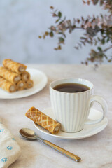 Coffee and dessert from waffle rolls with cream.