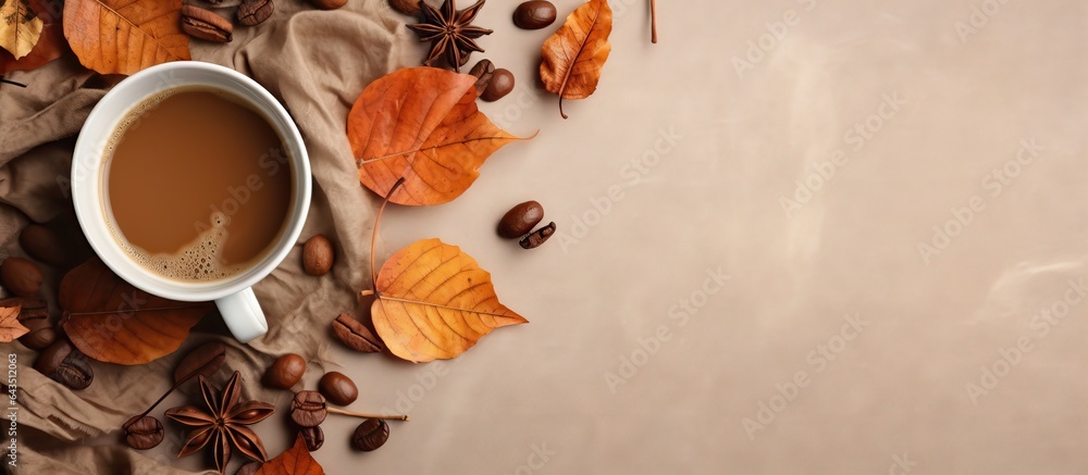 Poster flat lay composition in autumn or winter with a coffee cup dry leaves and dried orange on a linen fa