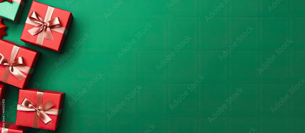 Poster Christmas card with red gift boxes on green background arranged in a flat lay top view and text space