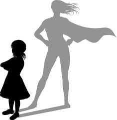 A superhero child or kid girl revealed by her shadow silhouette as a super hero in a cape.