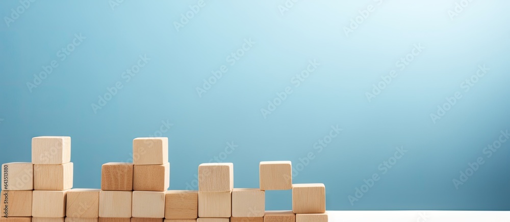 Aufkleber text space available on light blue background with a pyramid of wooden cubes