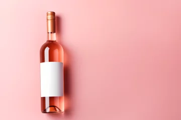 Fotobehang Wine bottle mockup, unopened bottle of rose wine on pink background, top view, copy space, flat lay © Nate