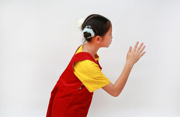 Portrait of Asian girl waved goodbye to her mother as she turned sideways on white background.