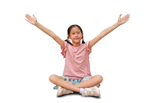 Asian girl child age about 8-9 years old sitting and arms outstretched or keeping arms raised isolated on white background. Kid with hands wide open.