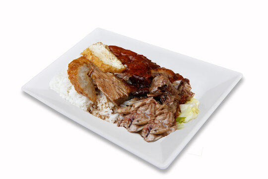 Roasted duck with rice on white plate, isolated background