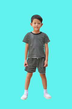 Smart Asian little boy child standing isolated on cyan background. Full length with clipping path.