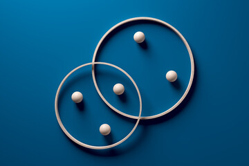 Crossing wooden rings with spheres on blue background.