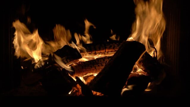 Beautiful shot of camp and fireplace fire burning in the dark at night.