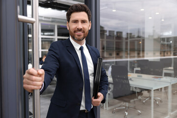 Real estate agent with leather portfolio inviting inside. Space for text
