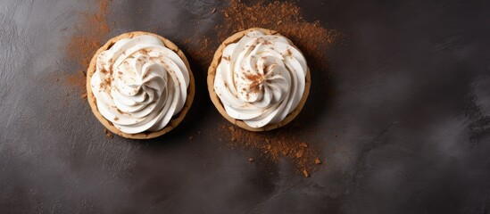 Breakfast concept Two meringue cream tartlets on a brown concrete background