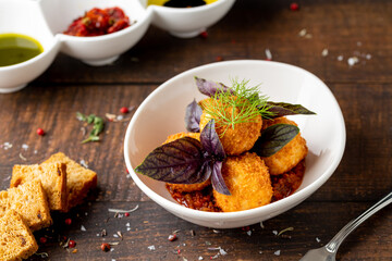 Homemade Fried Sicilian Arancini stuffed with meat, with tomato sauce