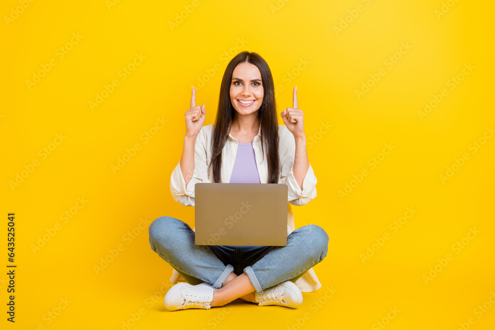 Poster full body portrait of lovely nice lady sit floor use netbook indicate fingers up empty space isolate