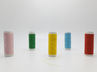 Multiple pieces of colorful thread spool on white isolated background