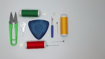 Neatly arranged sewing kit on white isolated background