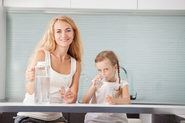Child with mother drinking water