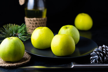 A ripe green apple fruits on dark stone table. Top view with copy space. Flat lay