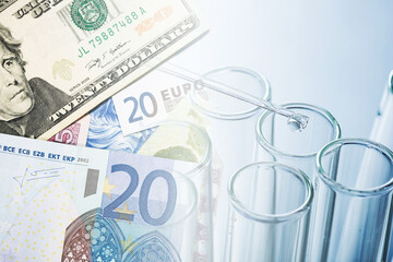 Research laboratory background. Fluid pipette drop into glass flask. Money background. Price of research. High price of medication. Cost of medicine.