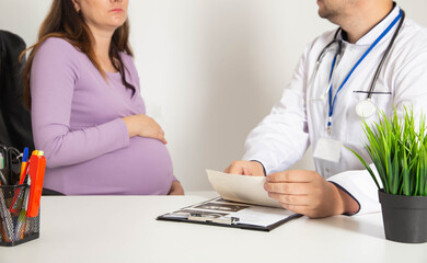 Pregnant girl in the doctor's office. Preservation of pregnancy in preterm labor and abdominal...