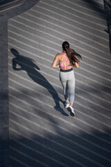 Sports buckground. The woman with runner on the street be running for exercise. Top view.