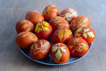 Easter eggs dyed with onion peel, dill and parsley. Natural eco dyes. Egg on the table top view food background.