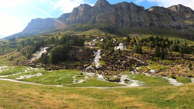 Scenic view of waterfalls created by rain in Ordesa park and Monte Perdido in Pyrenees, Spain.