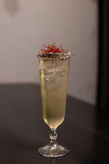 Conquistador cocktail consisting of aromatic tequila, bitters, fresh lime, honeysuckle and pepper syrup