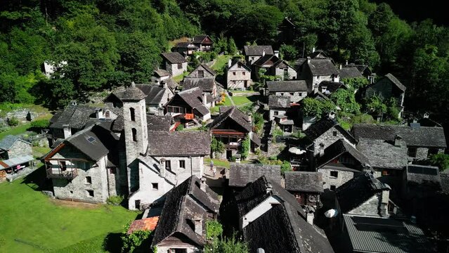 old stone village in switzerland mountains.Summertime in an ancient town with stone houses and a waterfall, aerial view of Foroglio, Sabbione, Ticino, Switzerland