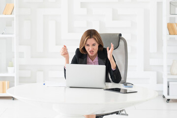 Tired frustrated and overworked business woman sitting in the office and thinking about problems in...