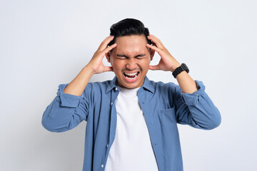 Portrait of annoyed young Asian man in casual shirt raising his hand, screaming with angry facial expression isolated on white background