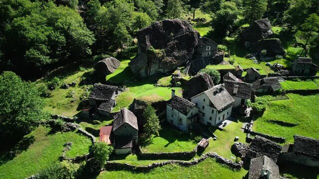 old stone village in switzerland mountains.Summertime in an ancient town with stone houses and a waterfall, aerial view of Foroglio, Sabbione, Ticino, Switzerland