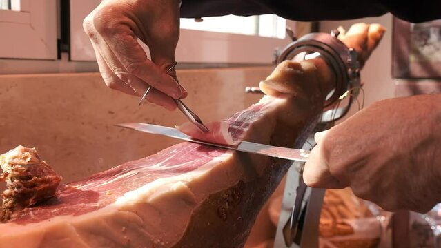 Iberian Ham cut with knife for a man