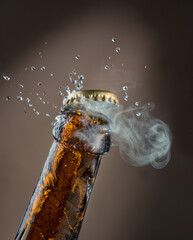 Beer bottle opening process. Beer fizzing and splashing from bottleneck under the cap.