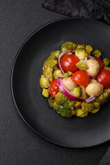 Delicious fresh salad with broccoli, cherry tomatoes, mushrooms, onions, salt, spices and herbs