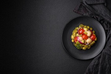 Delicious fresh salad with broccoli, cherry tomatoes, mushrooms, onions, salt, spices and herbs