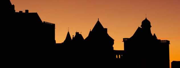 Silhouette of medieval castle on sunset background