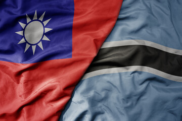 big waving national colorful flag of taiwan and national flag of botswana .