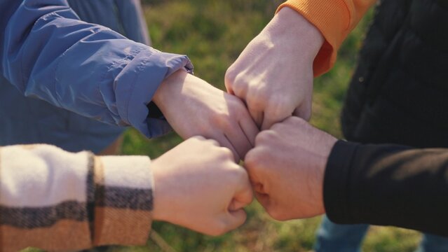 close-up fists a join together team. business team teamwork concept. close-up hands fists together group of people. team of young tourists fists together success business concept lifestyle