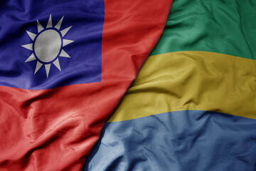 big waving national colorful flag of taiwan and national flag of gabon .