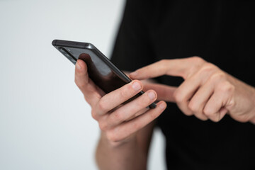 Man forefinger swiping phone screen. Male checking social media, running Internet, scooting through photos, web pages and news articles. High quality photo