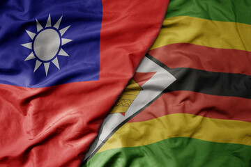 big waving national colorful flag of taiwan and national flag of zimbabwe .