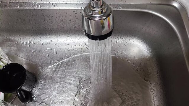 Kitchen faucet with a flowing water