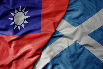 big waving national colorful flag of taiwan and national flag of scotland .