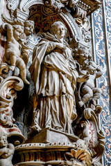 Fototapeta na wymiar Reliefs and statue in St Francesco d'Assisi church, Palermo, Sicily, Italy.