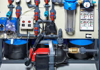 Surface centrifugal pump against the background of the water supply wiring diagram.