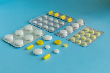 White and yellow tablets on a blue background