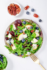 Salad with Pear, Arugula, Blue Cheese and Blueberry, Delicious Fresh Salad on Bright Background