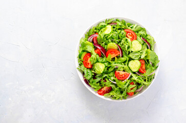 Healthy Vegetable Salad with Tomatoes, Arugula, Cucumbers and Onion, Diet Menu, Bright Background