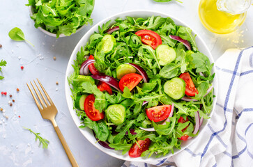 Healthy Vegetable Salad with Tomatoes, Arugula, Cucumbers and Onion, Diet Menu, Bright Background