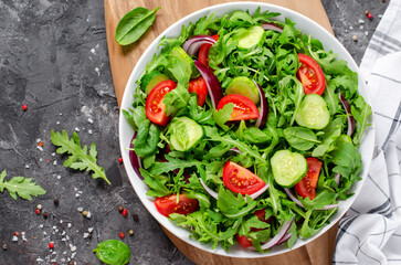 Healthy Vegetable Salad with Tomatoes, Arugula, Cucumbers and Onion, Diet Menu, Bright Background